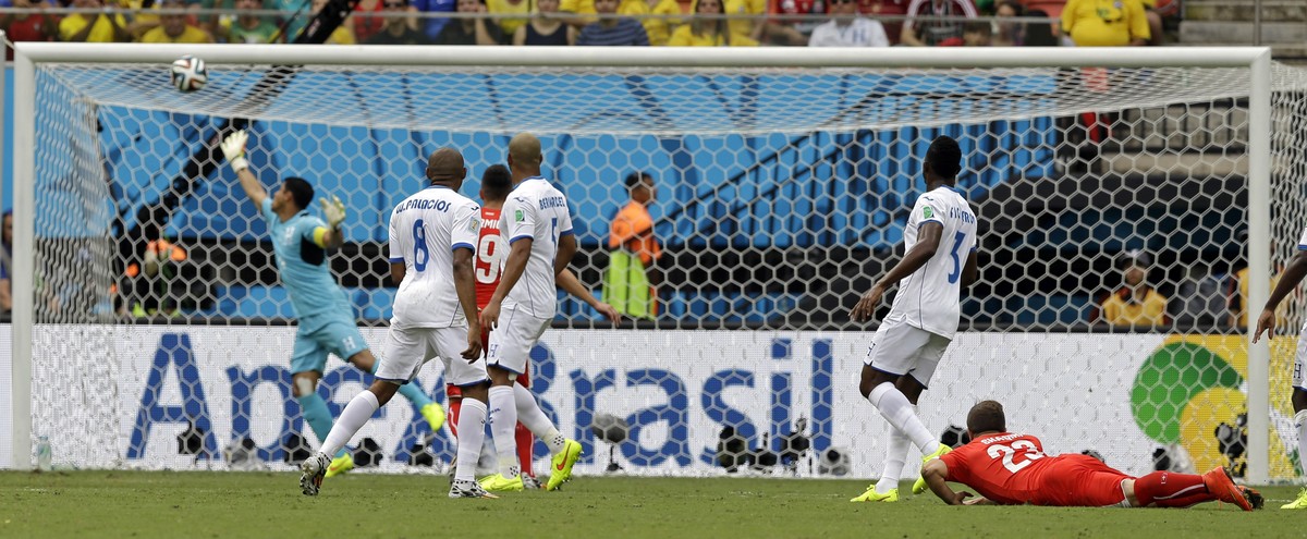 A shot from Switzerland's Xherdan Shaqiri, right, goes into the net for the opening goal during the group E World Cup soccer match between Honduras and Switzerland at the Arena da Amazonia in Man ...