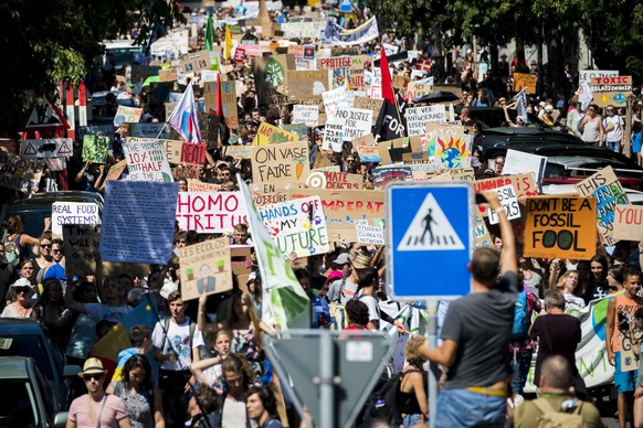 Swedish climate activist Greta Thunberg reacts with other young climate activists during a demonstration against climate change on the closing day of the « Smile for Future Summit for climate », in La ...