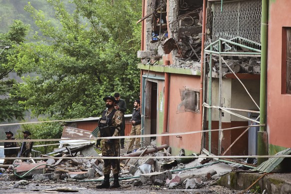 Army soldiers stand guard at a mosque building damaged by a suspected Indian missile attack near Muzaffarabad, the capital of Pakistan controlled Kashmir, on Wednesday, May 7, 2025. (AP Photo/M.D. Mug ...