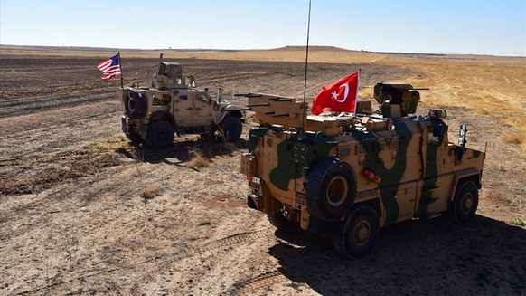 epa07903524 (FILE) - A handout photo made available by Turkey&#039;s National Defense Ministry shows Turkish and US army vehicles in Tal Abyad (Tell Abyad) city, at the Turkey-Syria border in northeas ...