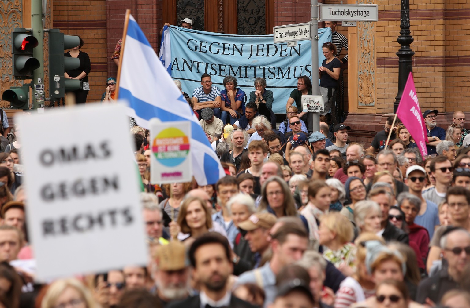 epa07917946 Protesters attend a demonstration against antisemitism and racism held outside the Neue Synagoge, or New Synagogue (unseen), in Berlin, Germany, 13 October 2019. Organized by the &#039;Unt ...