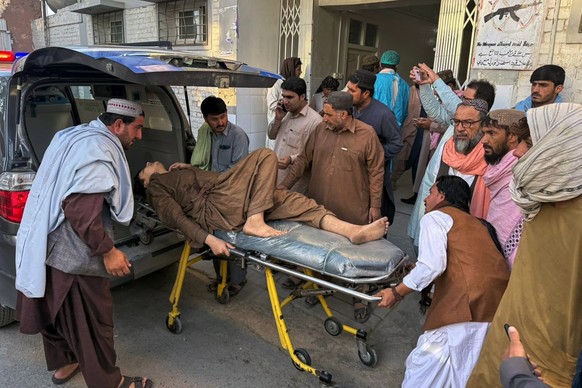People bring a man, who was injured in the clashes between Pakistan and Afghan forces in border area, for medical treatment at a hospital in Chaman, a town on the Pakistan side of the border, Wednesda ...
