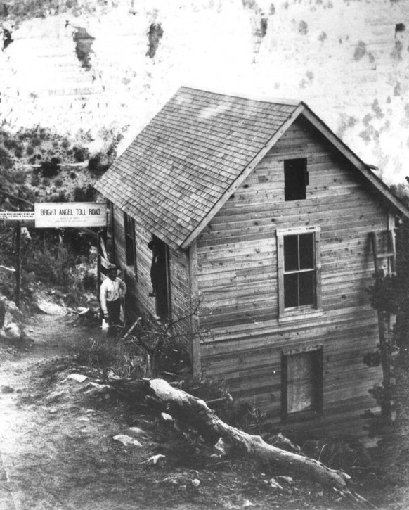 Kolb studio with the Bright Angel Trail toll gate. Emery is standing, Ellsworth is in the doorway, circa 1904.
