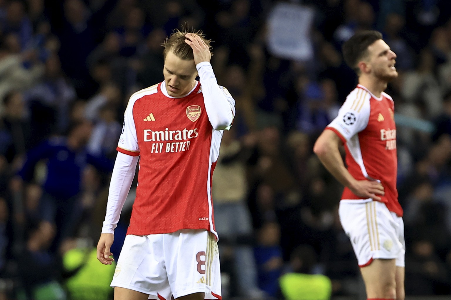 Arsenal&#039;s Martin Odegaard and Declan Rice, right, react after Porto&#039;s Galeno scored the opening goal during a Champions League round of 16 soccer match between FC Porto and Arsenal at the Dr ...