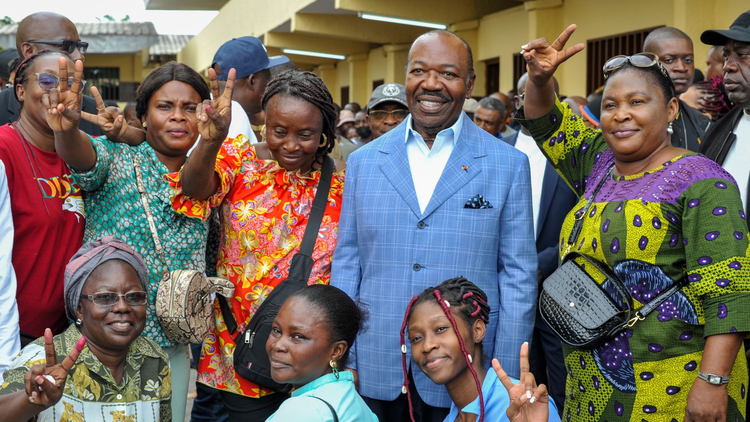 epa10821772 Gabonese President Ali Bongo Ondimba (2-R), poses with supporters after casting his vote during the 2023 Gabonese general elections in Libreville, Gabon, 26 August 2023. A little under 850 ...