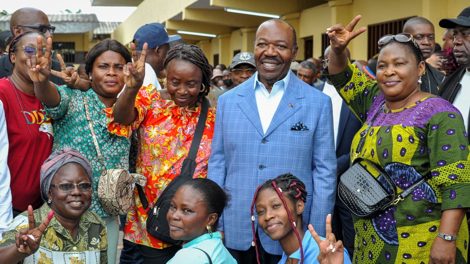 epa10821772 Gabonese President Ali Bongo Ondimba (2-R), poses with supporters after casting his vote during the 2023 Gabonese general elections in Libreville, Gabon, 26 August 2023. A little under 850 ...