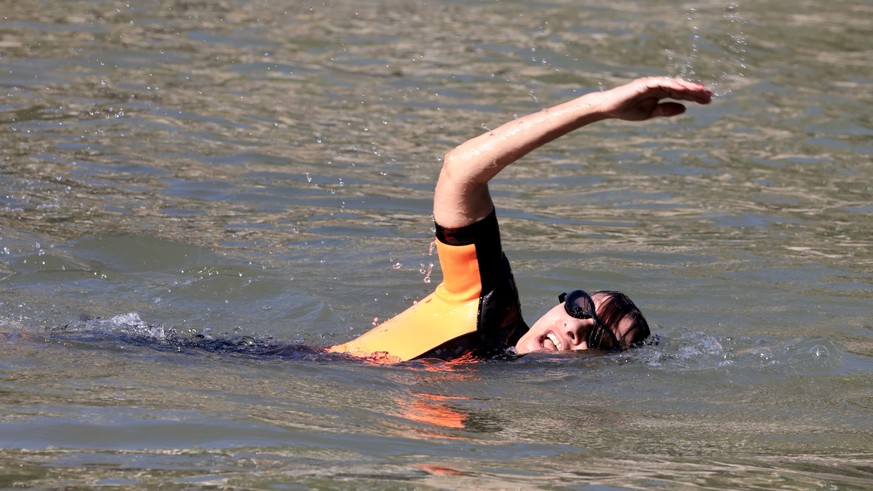 epa11483077 Paris Mayor Anne Hidalgo swims in the Seine to demonstrate that the river is clean enough to host the outdoor swimming events at Paris 2024 Olympic Games, in Paris, France, 17 July 2024. D ...