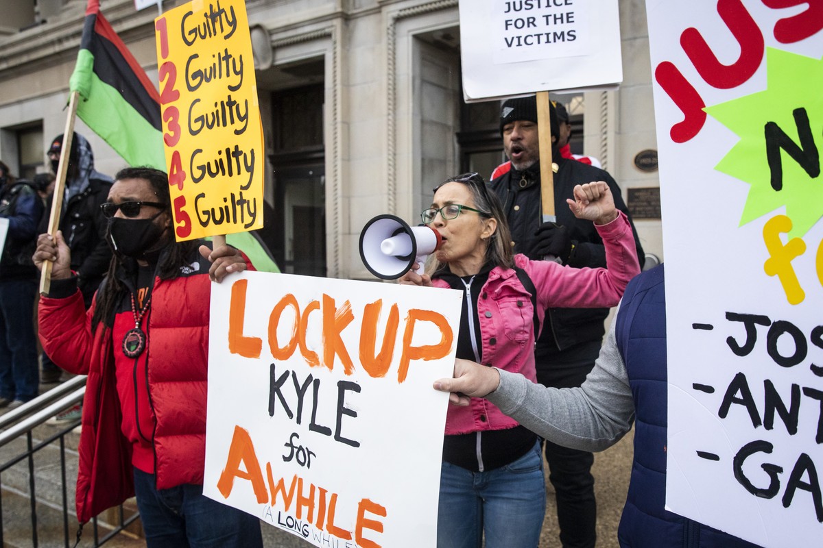 Jacob Blake's uncle, Justin Blake, left, in red, joins protesters on both sides of the Kyle Rittenhouse case on the steps of the Kenosha County Courthouse while the jury deliberates for the secon ...