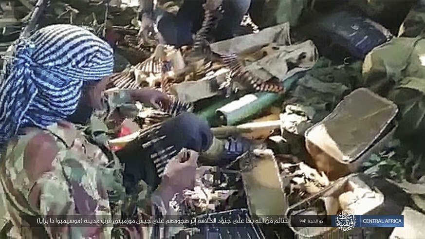 This image distributed online by the Islamic State Central Africa Province (ISCAP) and provided by SITE Intelligence Group shows ISCAP fighters and weapons following clashes with Mozambican government ...
