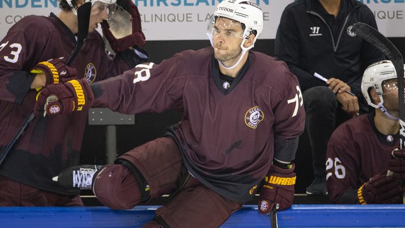 Geneve-Servette&#039;s forward Marc-Antoine Pouliot jumps over the board, during the pre-season game of the National League between Geneve-Servette HC and SC Bern, at the ice stadium Les Vernets, in G ...