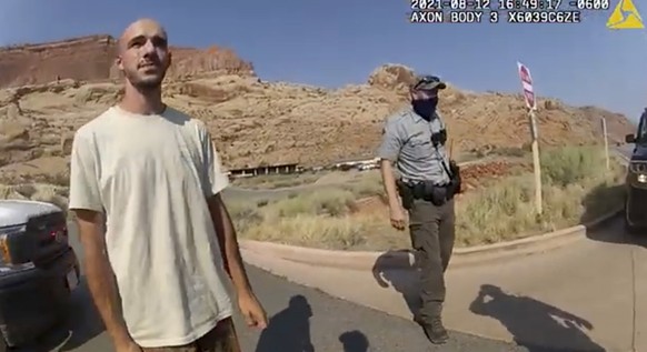 FILE - This Aug. 12, 2021 file photo from video provided by the Moab, Utah, Police Department shows Brian Laundrie talking to a police officer after police pulled over the van he was traveling in with ...