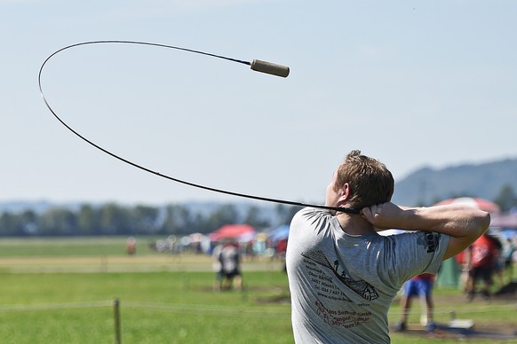 29.08.2015; Limpach; Eidgenoessisches Hornusser Fest; 
A man performs during the traditional Swiss sports event &quot;Hornussen&quot;, on Saturday, August 29, 2015, in Limpach, Switzerland. The target ...