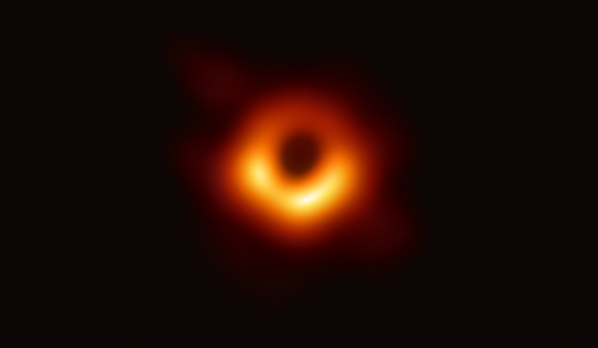 epa07496265 An undated handout photo made available by Event Horizon Telescope Collaboration on 10 April 2019 showing a bright ring formed as light bends in the intense gravity around a black hole tha ...
