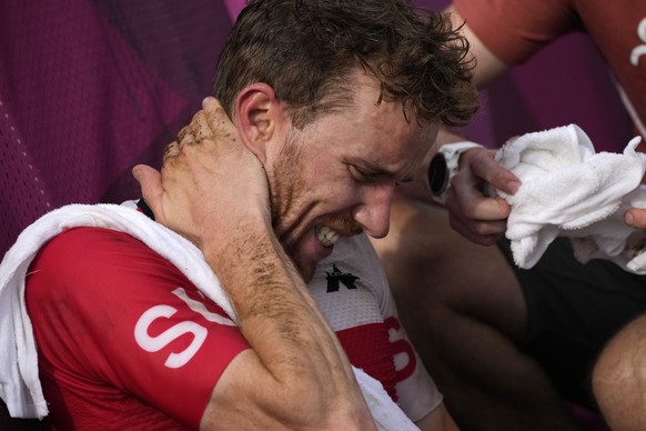 Mathias Flueckiger of Switzerland, who took the silver medal, reacts after the finish of the men&#039;s cross country mountain bike competition at the 2020 Summer Olympics, Monday, July 26, 2021, in I ...