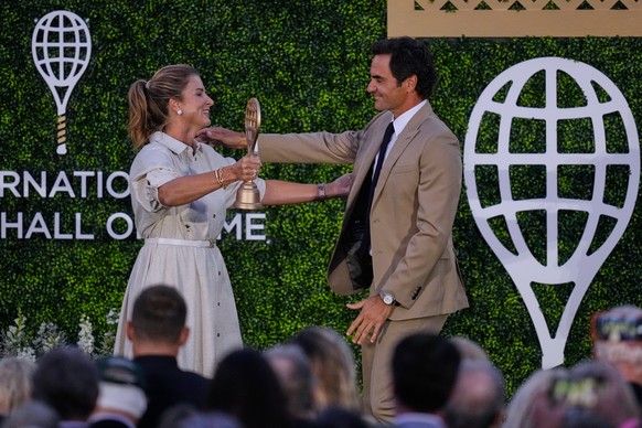 Roger Federer embraces his wife Mirka during his induction ceremony at the International Tennis Hall of Fame, Saturday, Aug. 29, 2026, in Newport, R.I. (AP Photo/Charles Krupa)
Roger Federer
