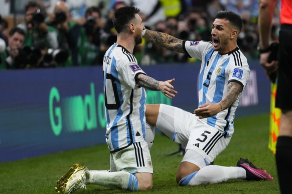 Argentina&#039;s Lionel Messi, left, and Argentina&#039;s Leandro Paredes celebrate after a goal during the World Cup final soccer match between Argentina and France at the Lusail Stadium in Lusail, Q ...