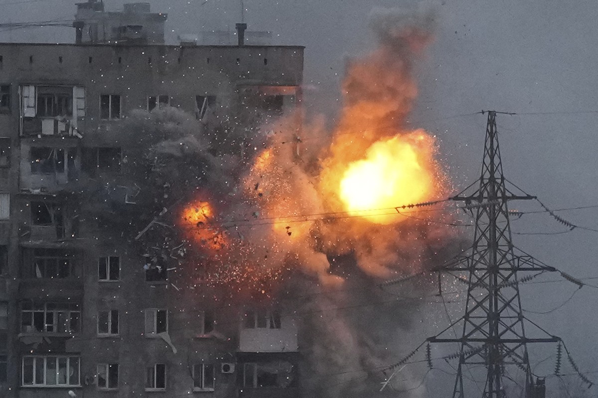 An explosion in an apartment building that came under fire from a Russian army tank in Mariupol, Ukraine, Friday, March 11, 2022. Ukraine