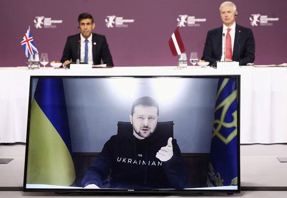 Ukrainian President Volodymyr Zelenskyy speaks via video link as Latvian Prime Minister Krisjanis Karins and British Prime Minister Rishi Sunak listen, during the Joint Expeditionary Force (JEF) meeti ...