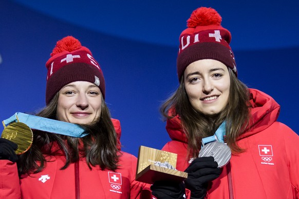 Gold medal winner Sarah Hoefflin of Switzerland, left, and Silver medal winner Mathilde Gremaud of Switzerland, right, celebrates during the victory ceremony on the Medal Plaza for the women Freestyle ...