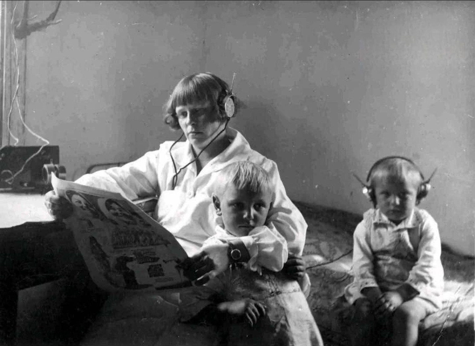 Mother and her two children listening to the radio, Karczew, Poland, 1932.