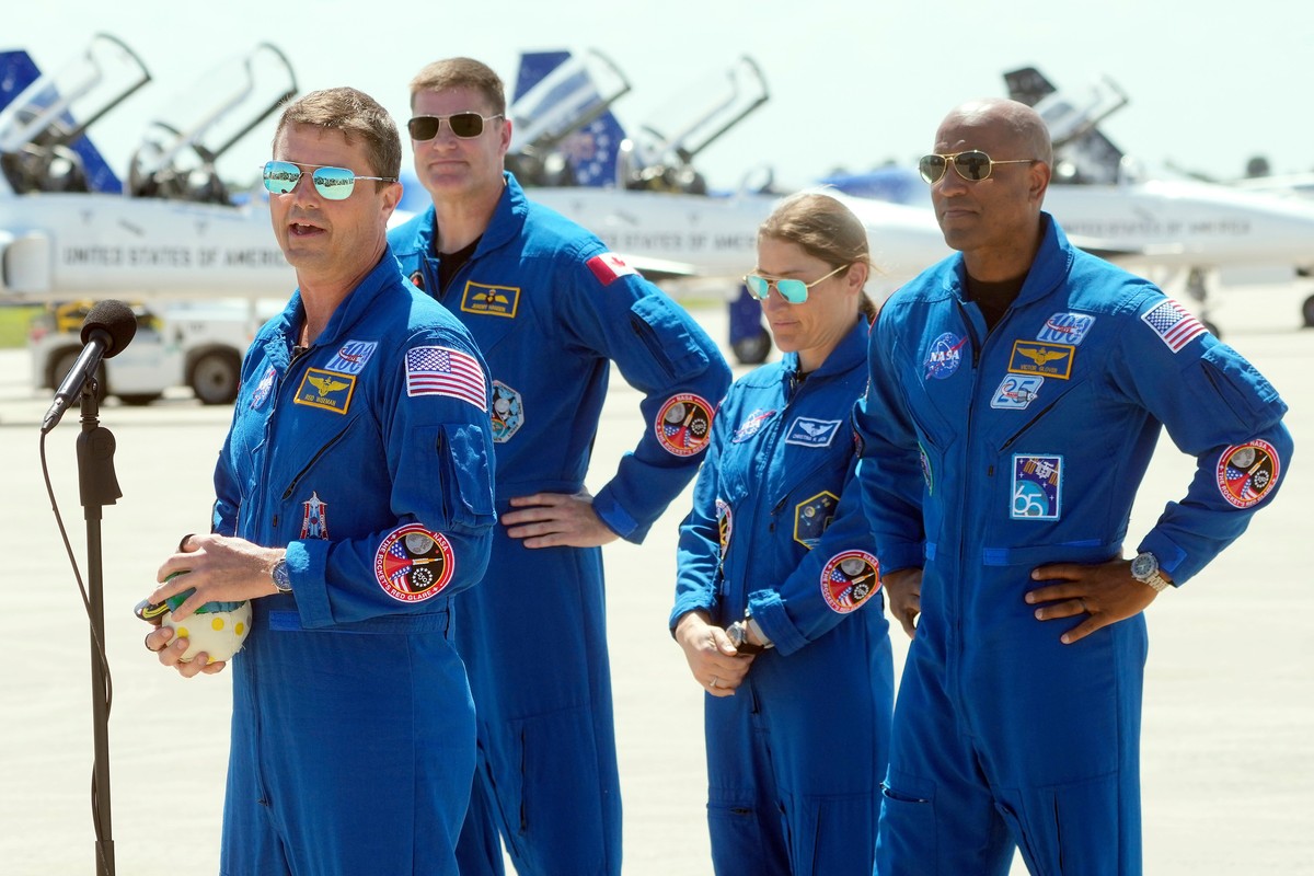 Artemis 2 crew members, from left; Commander Reid Wiseman, Mission Specialist Jeremy Hansen, of Canada, Mission Specialist Christina Koch, and Pilot Victor Glover speak to the media after the crew ...