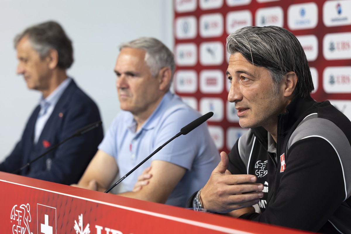 Switzerland's head coach Murat Yakin, team director Pierluigi Tami and Dominique Blanc, president of the Swiss football federation, front to back, attend a press conference at the "Stadion a ...