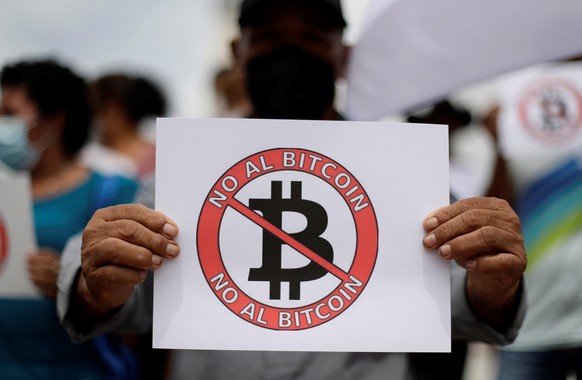 epa09432813 Former guerrillas and veterans of the Army of El Salvador protest against the use of bitcoin as legal currency, in San Salvador, El Salvador, 27 August 2021. A group of ex-guerrillas and v ...