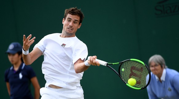 epa07704032 Guido Pella of Argentina in action against Milos Raonic of Canada during their fourth round match for the Wimbledon Championships at the All England Lawn Tennis Club, in London, Britain, 0 ...