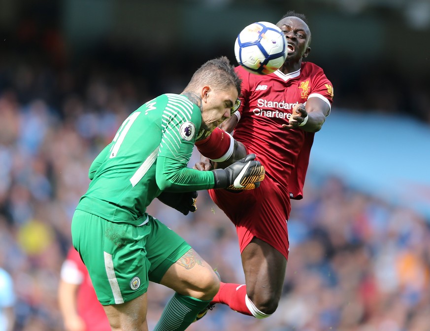 epa06193881 Manchester City's goalkeeper Ederson Santana de Moraes (L) is fouled by Liverpool's Sadio Mane during the English Premier League soccer match between Manchester City and Liverpool FC at th ...