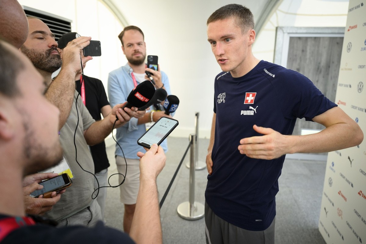 Switzerland's midfielder Michel Aebischer speaks to journalists during a mixed zone after a closed training session of Swiss national soccer team in preparation for the FIFA World Cup Qatar 2022  ...