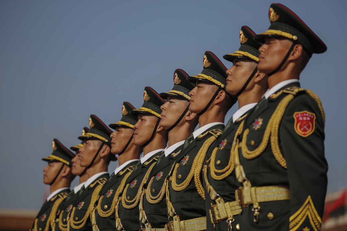 epa08707398 Chinese People's Liberation Army (PLA) honor guards stand in line ahead of the flower-basket-laying ceremony for the monument to the people's heroes ahead of Chinese National Day ...
