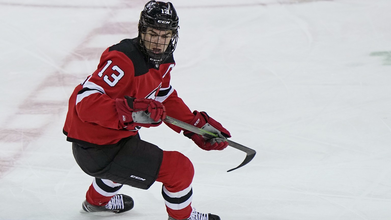 New Jersey Devils center Nico Hischier (13) wears a cage over his face as he returns to the ice after having surgery Feb. 27 to repair a broken nose during the first period of an NHL hockey game again ...