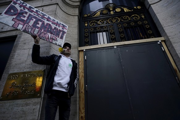 Lucas Camp, of Astoria, holds a sign at Trump Tower, Tuesday, April 4, 2023 in New York.  Former President Donald Trump will surrender in Manhattan on Tuesday to face criminal charges for 2…