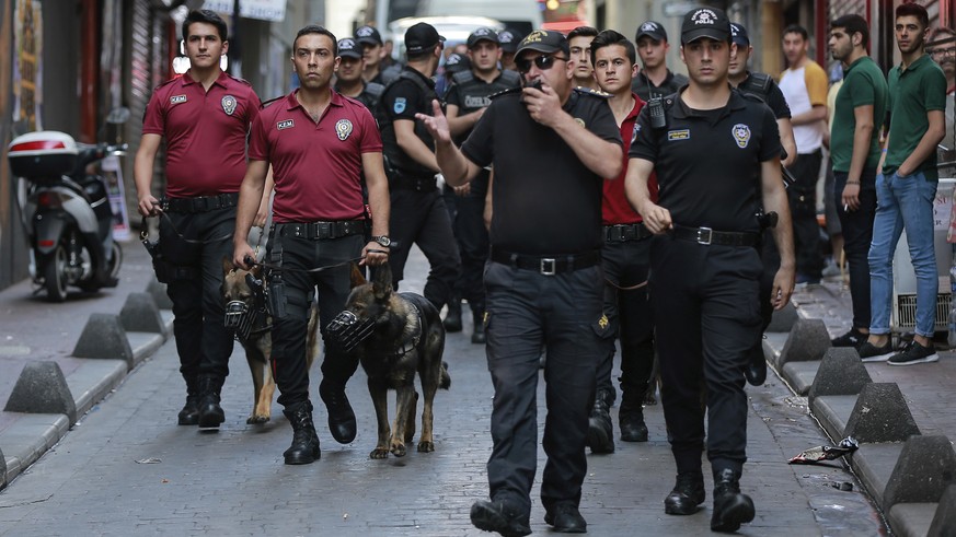 A phalanx of police officers follow Turkey&#039;s lesbian, gay, bisexual, trans and intersex activists as they march despite a ban, in Istanbul, Sunday, July 1, 2018. The Istanbul LGBTI+ activists gat ...