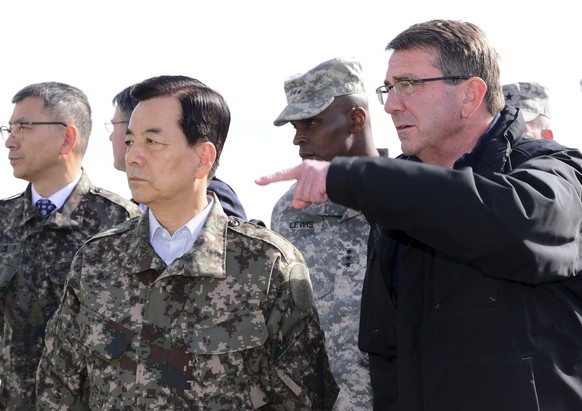 U.S. Defense Secretary Ash Carter, right, and South Korean Defense Minister Han Min Koo look towards North Korea at an observation post near the border village of Panmunjom, which has separated the tw ...