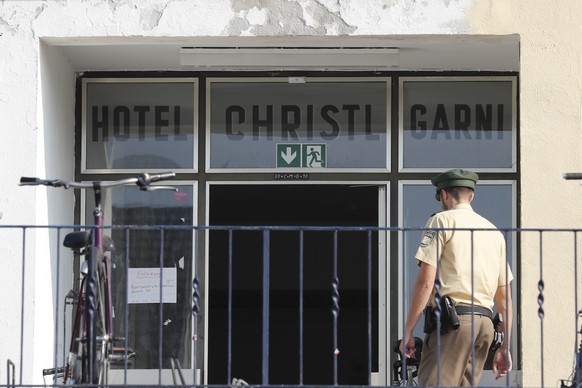 A police officer enters a former hotel where a Syrian man lived before the explosion in Ansbach, Germany, Monday, July 25, 2016. Bavaria&#039;s top security official says a man who blew himself up aft ...