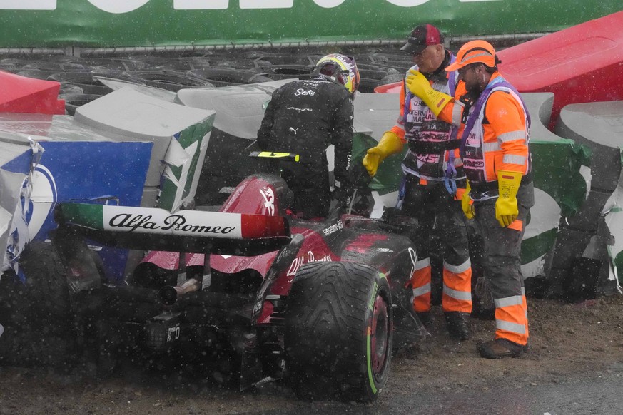 Alfa Romeo driver Guanyu Zhou of China leaves his car after crashing during the Formula One Dutch Grand Prix at the Zandvoort racetrack, in Zandvoort, Netherlands, Sunday, Aug. 27, 2023.(AP Photo/Pete ...