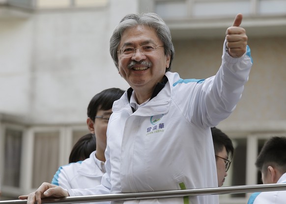 Chief Executive candidate, Hong Kong&#039;s former Financial Secretary John Tsang gives a thumbs-up to supporters at an election campaign in Hong Kong, Friday, March 24, 2017. Hong Kong is poised to c ...