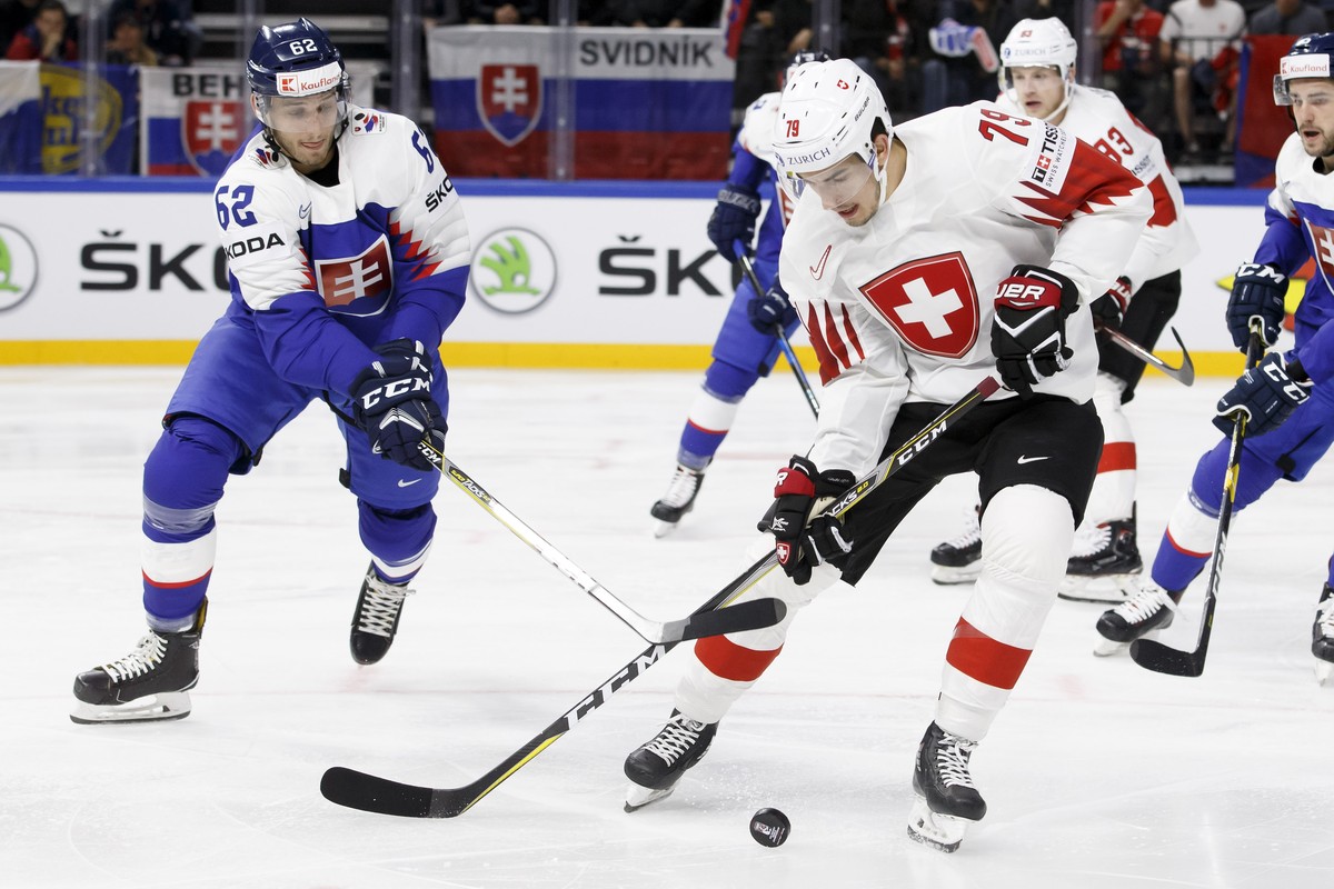 Slovakia's defender Christian Jaros, left, vies for the puck with Switzerland's forward Damien Riat, right, during the IIHF 2018 World Championship preliminary round game between Slovakia an ...