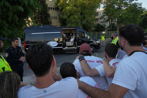 Freed Israeli hostage Evyatar David gestures from a van as he arrives at Beilinson hospital in Petah Tikva, Israel, after he was released from Hamas captivity in the Gaza Stripl, Monday, Oct. 13, 2025 ...