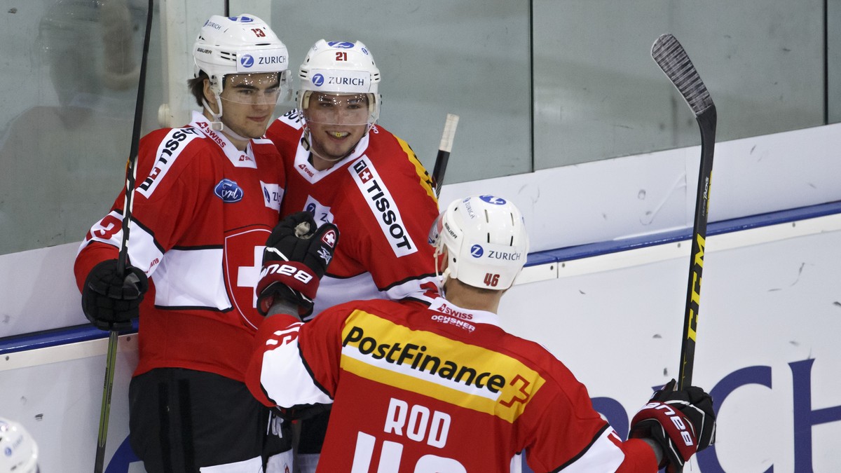 Switzerland's forward Nico Hischier, left, celebrates his goal with teammates forward Kevin Fiala, center, and forward Noah Rod, right, after scoring the 3:1, during a friendly international ice  ...