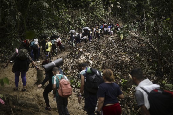 Migrants walk across the Darien Gap from Colombia to Panama in hopes of reaching the U.S., Tuesday, May 9, 2023. The image was part of a series by Associated Press photographers Ivan Valencia, Eduardo ...