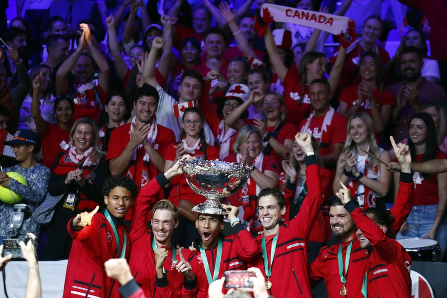 Team Canada celebrate with the trophy after winning the Davis Cup tennis final in Malaga, Spain, Sunday, Nov. 27, 2022. (AP Photo/Joan Monfort)