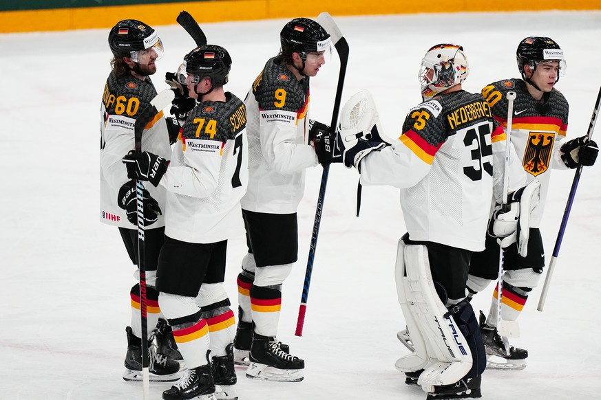 Germany&#039;s team players celebrate as they won the group A match between Germany and Hungary at the ice hockey world championship in Tampere, Finland, Sunday, May 21, 2023. (AP Photo/Pavel Golovkin ...