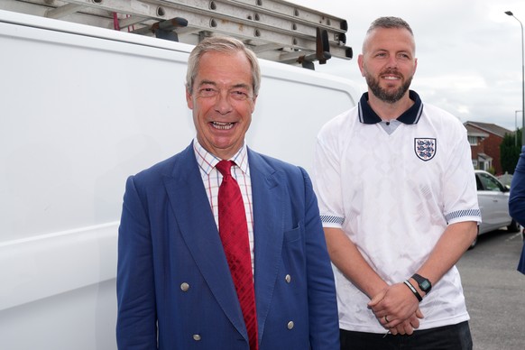 Britain's Reform Party leader Nigel Farage and local candidate Rob Kenyon arrive at a polling station for a by-election in Makerfield, England, Thursday, June 18, 2026.(AP Photo/Jon Super)
Britai ...