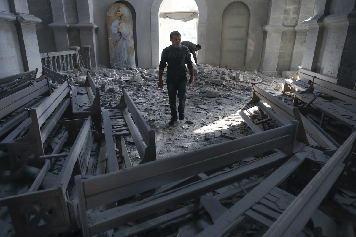 A man walks in rubbles of the Ghazanchetsots (Holy Saviour) Cathedral in the city of Shusha, some 15 kilometers from the Nagorno-Karabakh province's capital Stepanakert, Thursday, Oct. 8, 2020, a ...