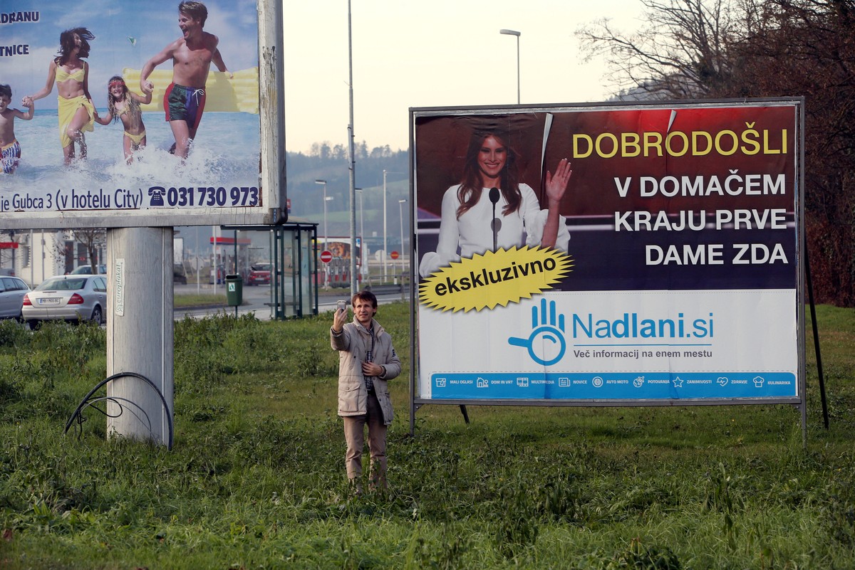A man takes a selfie in front of placard with a picture of Melania Trump in her hometown Sevnica, Slovenia, December 1, 2016. Banner reads "Welcome in hometown of first lady of U.S.".REUTERS ...