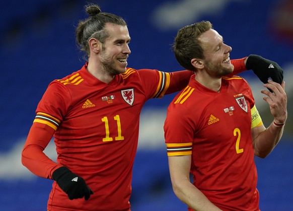 epa09102318 Gareth Bale (L) and Chris Gunter (R) of Wales react at the end of the international friendly match between Wales and Mexico in Cardiff, Britain, 27 March 2021. EPA/TIM KEETON