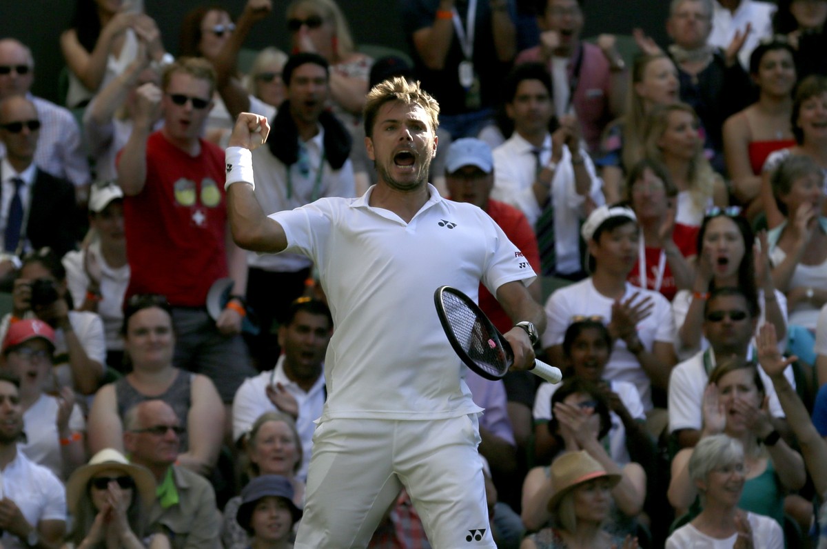 Switzerland's Stan Wawrinka celebrates after winning the third set of his Men's Singles first round match against Grigor Dimitrov of Bulgaria, at the Wimbledon Tennis Championships in London ...