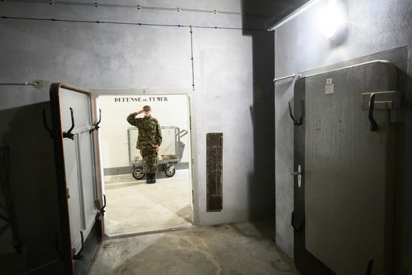 Soldier of the Swiss Army Honor Troop dressed in period uniforms stands in the ammunition room of the artillery fort of Dailly, T2, one of the largest and most heavily armed forts in Switzerland, in L ...